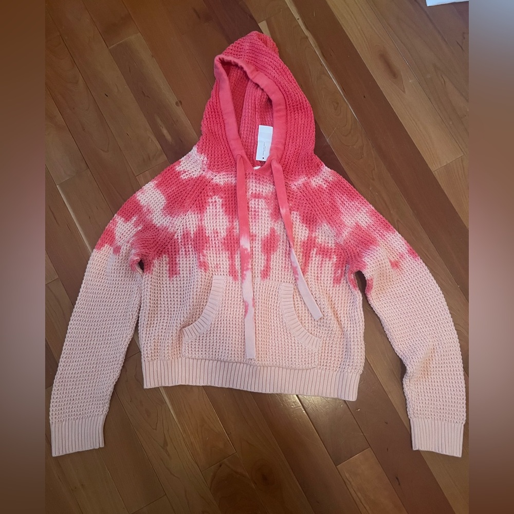 A cropped hooded sweater, new with tags on it. Comfy and cute!
